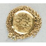 A 9ct gold locket, circular with engraved decoration, 9.4g.