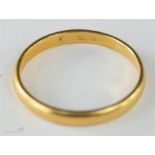 A gold wedding band, worn hallmarks, size P, 2.7g.