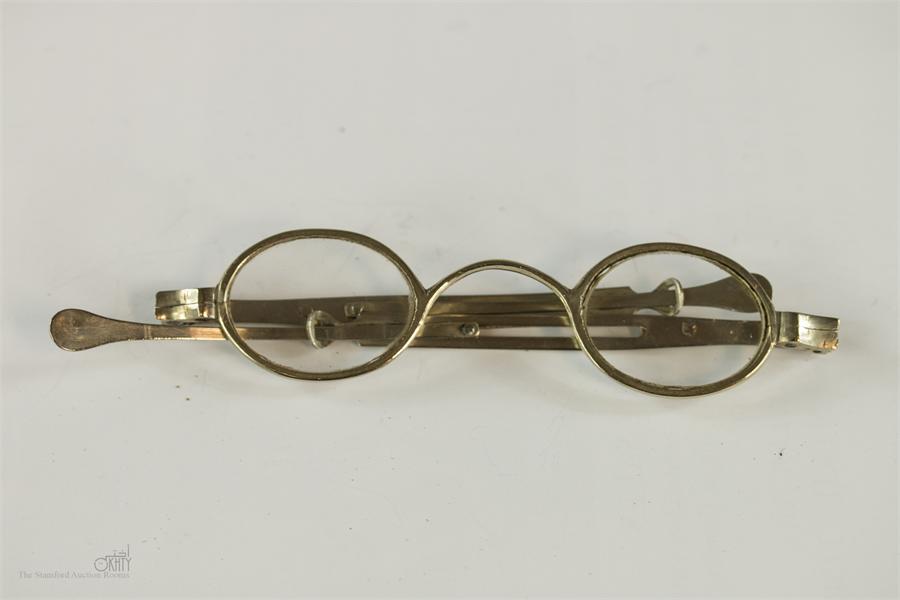 A pair of silver spectacles with extending sides circa 1850.