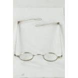 A pair of silver spectacles with mid-folding sides engraved to the side D14, loop ends, circa 1830.