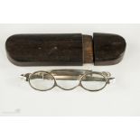 A pair of 19th century silver spectacles marked JW, with extending sides and with a rosewood ‘pull