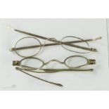 Two pairs of 19th century silver spectacles, one marked pebbles, the other with mod folding arms,