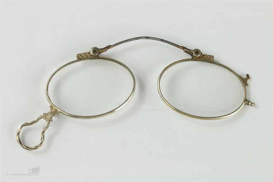 A pair of silver folding nose spectacles, mid 18th century, engraved with decoration.