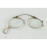 A pair of silver folding nose spectacles, mid 18th century, engraved with decoration.