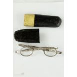 A pair of 19th century silver spectacles with extending sides, with a 19th century papier mache pull