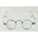 A pair of early 19th century silver spectacles with hoop ends to the sides.