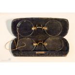 Two pairs of Pince Nez spectacles, one with a gold bridge and ear loop, the other with a snakeskin