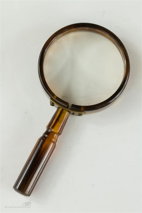 A tortoiseshell magnifying glass.