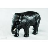 A ceramic elephant, 8cm high.