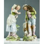 A pair of porcelain figures, possibly German, the lady with parrot and the gentleman with monkey