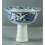 A blue and white Chinese stem cup with enamelled decoration depicting a quilin to the centre.