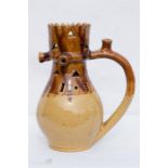 A treacle glazed stonware puzzle jug.