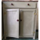 A pine painted cupboard with single drawer and two cupboard doors below.