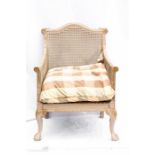 A French painted bergere chair, with checkered fabric.