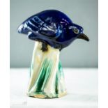 An unusual 19th century blue glazed stoneware bird, raised on a green glazed base.