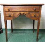 An 18th century oak low boy with single long drawer, pierced and shaped apron and square tapered