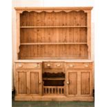 A 19th century pine dresser and rack, the rack with dentil moulded cornice and up hooks, above the
