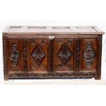 A 17th century oak coffer, four panelled lid and front panels carved with diamond and rosettes,