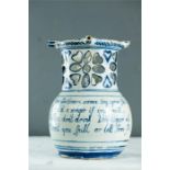 A 19th century blue and white glazed stoneware puzzle jug bearing inscription to the body.