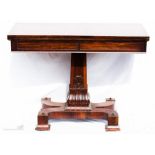 A fine Regency rosewood tea table with drawers to each end, the square tapered column carved with