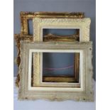 A mixed group of giltwood and carved frames, of graduated size.