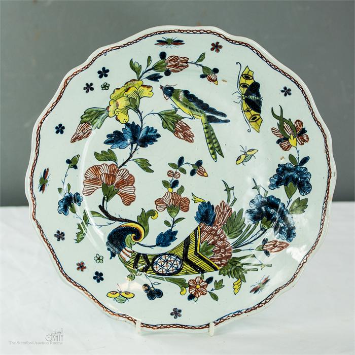 A polychrome plate depicting a cornucopia and butterflies.