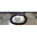 A pair of Derby dishes with gilt grape and vine borders and an oval dish with cobalt blue border.