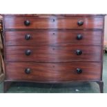 A Georgian mahogany serpentine chest of drawers, with four graduated drawers, and raised on