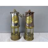 Two brass miners lamps.