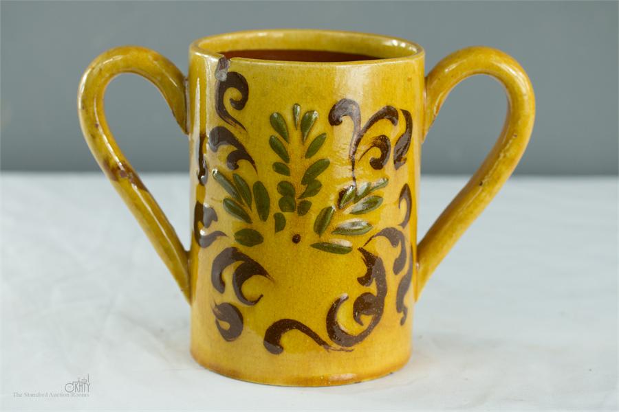 An early 19th century slipware twin handled mug, 'Happiness Lies in Imagination Not in Possession, - Image 2 of 2