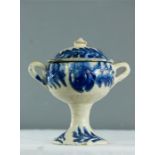 A 19th century twin handled stem cup with cover, blue slip glazed.