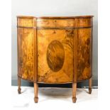 A 19th century demi-lune satinwood and mahogany commode with oval veneered sides and door, raised on