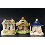 Three 19th century Staffordshire pastille burners in the form of houses.