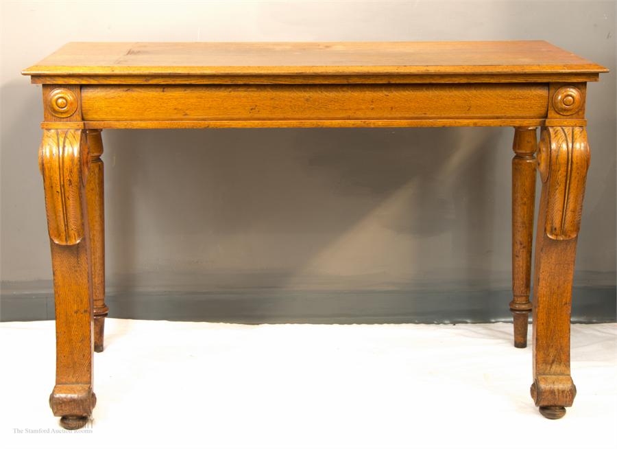 A late Regency oak console table, carved legs, with secret drawer to the side, 82 by 129 by 86cm.