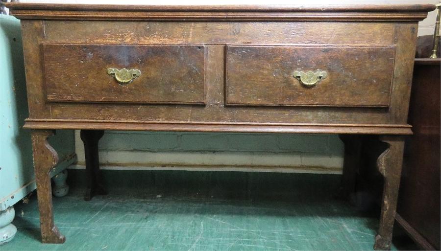 An 18th century oak dresser base, with two drawers and turned legs. 81 by 127 by 42cm.