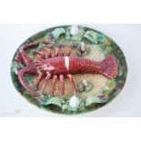 A Palissey type plate, modelled with lobster to the centre, 30 cm diameter.