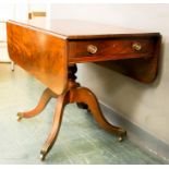 A Regency mahogany table with two drop leaves, a single drawer and corresponding dummy drawers,