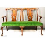 A George II walnut settee, with scallop shell motif, pierced splats, cabriole legs and ball & claw