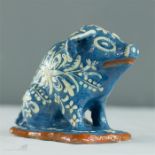 A terracotta blue glazed pig money box.
