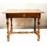A 17th century oak side table with a single drawer, turned legs, and H-form stretcher, 66 by 88 by