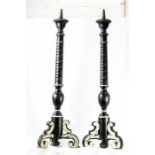 A pair of large Italian wooden pricket sticks, painted black and silver, 98cm high.