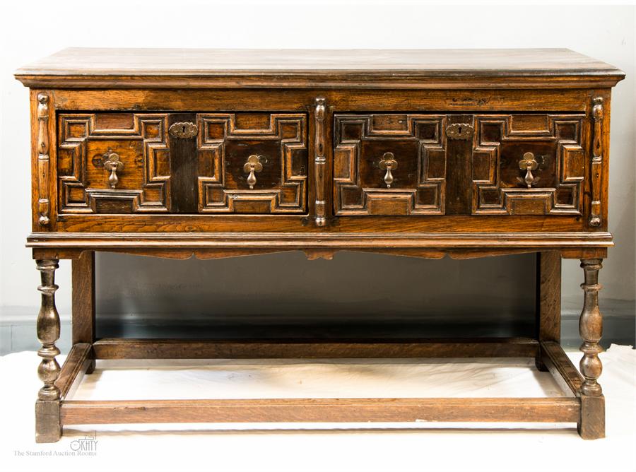 A 17th century and later dresser base with geometric moulded drawers, turned legs and peripheral