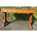 A satinwood free standing library table with red leather tooled top, 80 by 126 by 63cm.