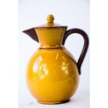 A terracotta yellow glazed coffee pot, inscribed 819 to the base.