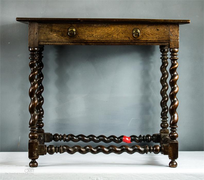 An early 18th century oak side table with barleytwist legs and stretchers, 70 by 50 by 56cm.