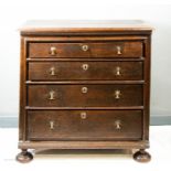 A 17th century oak chest of drawers, with four graduated long drawers, divided by moulding, on