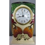 A Moorcroft clock, dated '98, monogrammed CH, initailled DJS, 16½cm high.