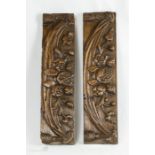 A pair of carved oak panels depicting pomegranites.