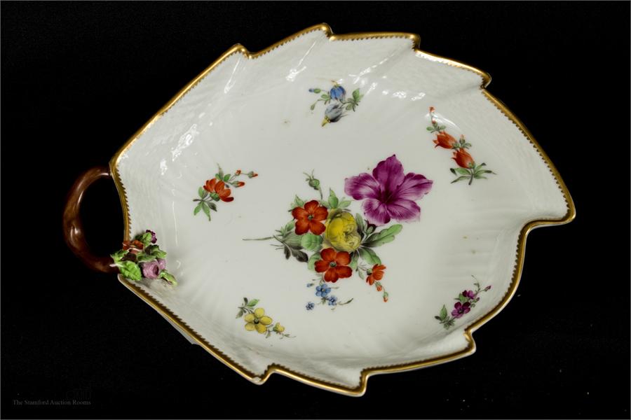 An early Copenhagen porcelain dish, painted with flowers in a leaf design, with branch form handle