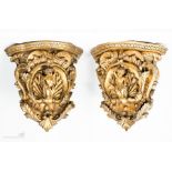 A pair of carved giltwood wall brackets, with cherubs to the centre.